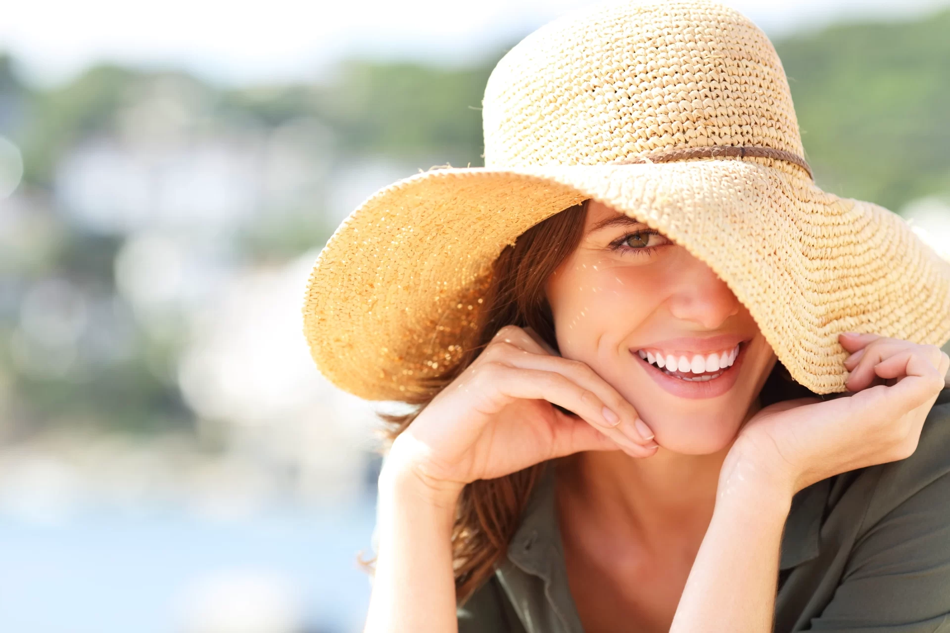 close up of woman in hat smiling