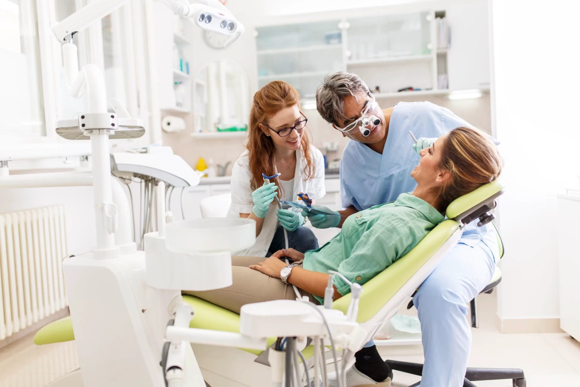 dentist and dental hygienist working with patient